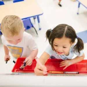 Montessori environment with children engaged in individual learning tasks.