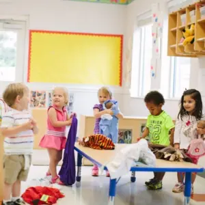 Children learning through discovery in a Montessori outdoor environment.