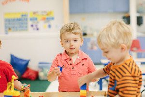 Children exploring sensory materials in a Montessori classroom.