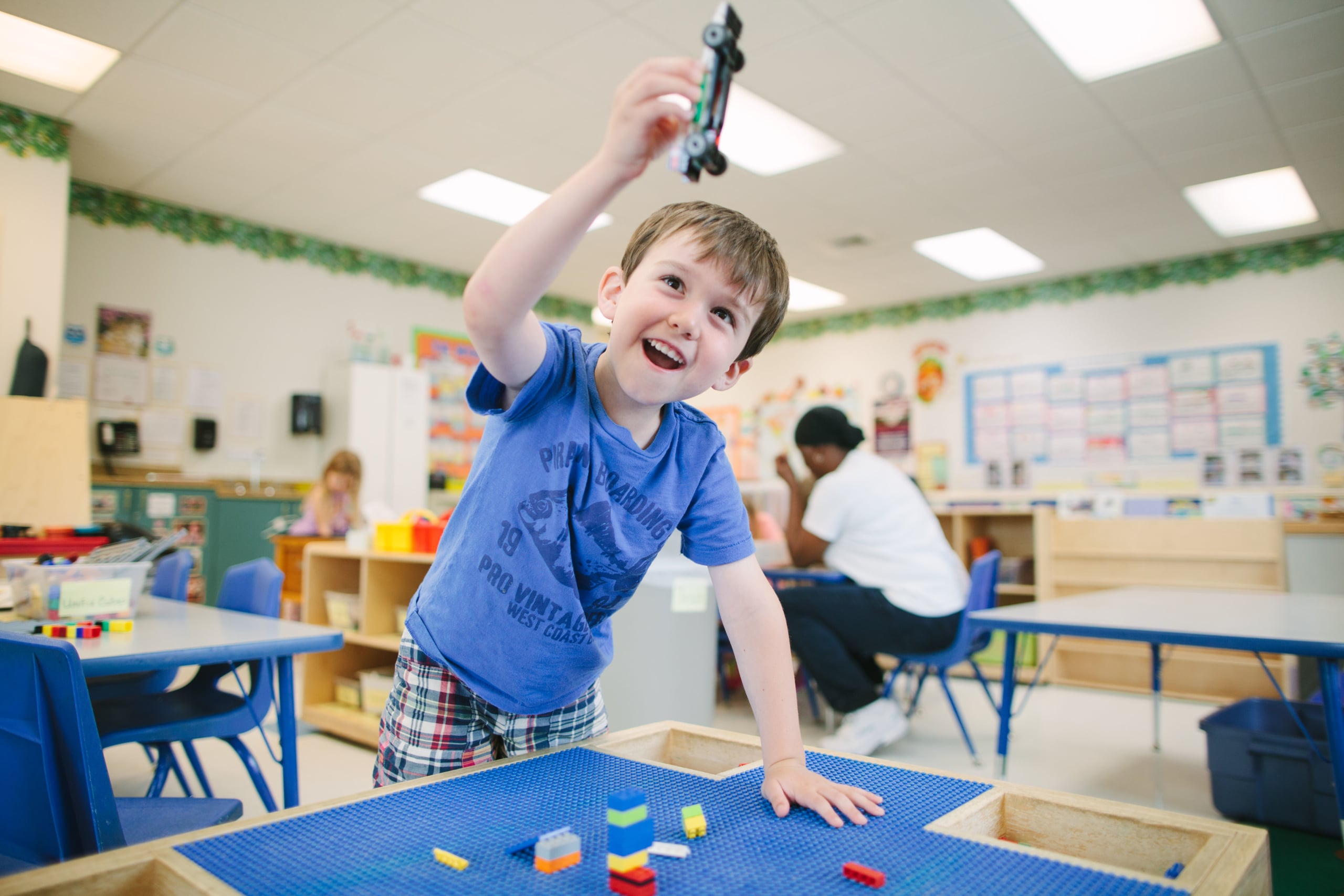 Child using Montessori sandpaper letters for language development.