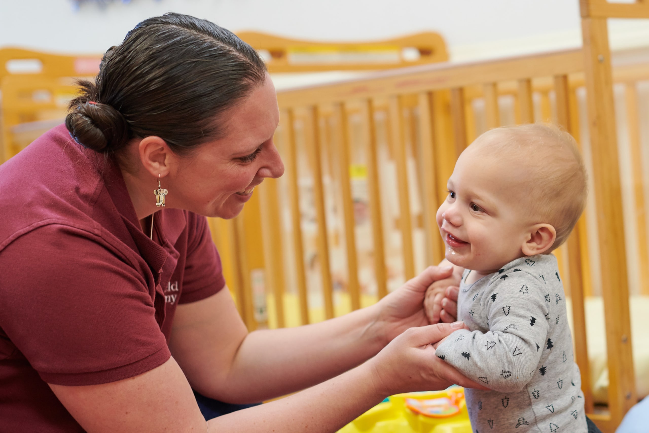 Child using Montessori sandpaper letters for language development.